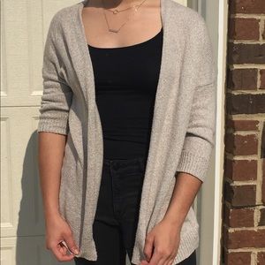 Beige cardigan with three quarter sleeves.